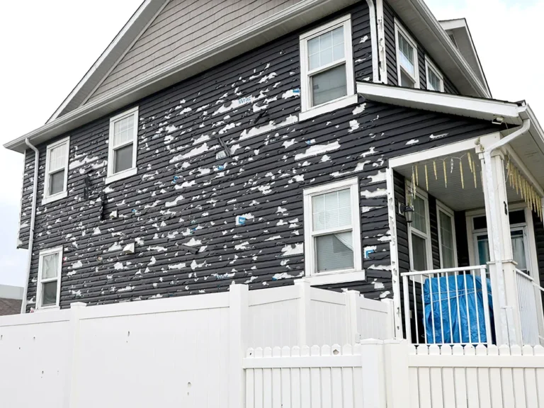Hail-damaged siding on the exterior of a Calgary home