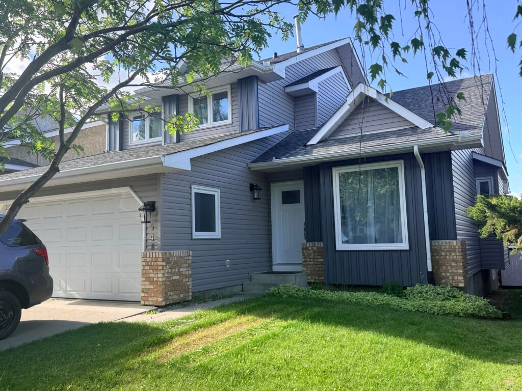 Complete exterior renovation in Country Hills, NE Calgary, featuring a new Class 4 impact-resistant roof, new gutters, and board and batten vinyl siding.