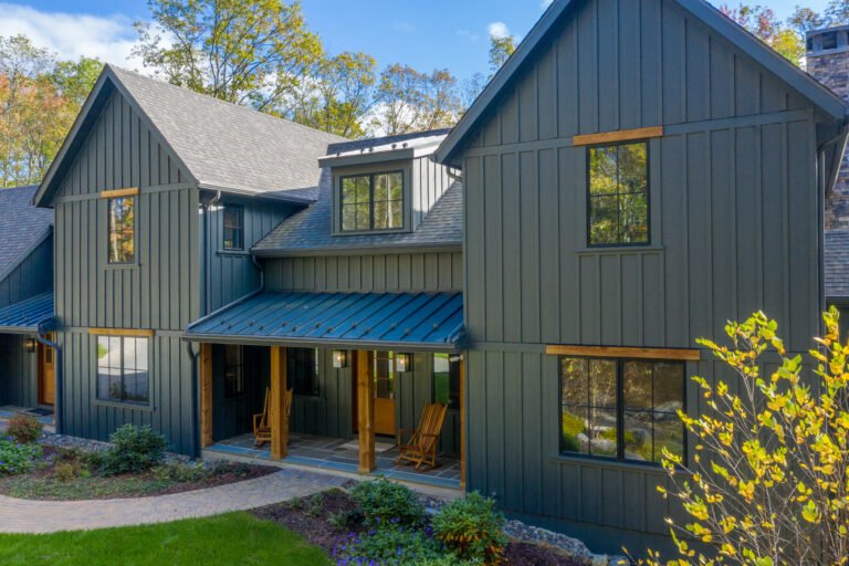 Charcoal board-and-batten siding with wood accents and a covered front porch